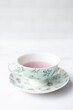 © Lauren Lee/Stocksy - Pretty cup of tea and saucer