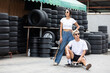 © offsuperphoto - portrait man and woman skateboarder with sunglasses and fashion pose in front of garage tire