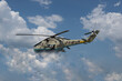 A khaki-painted military helicopter with a set of missiles flies into the clouds.
