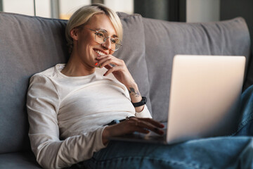 Sticker - Smiling mid aged blonde woman studying online