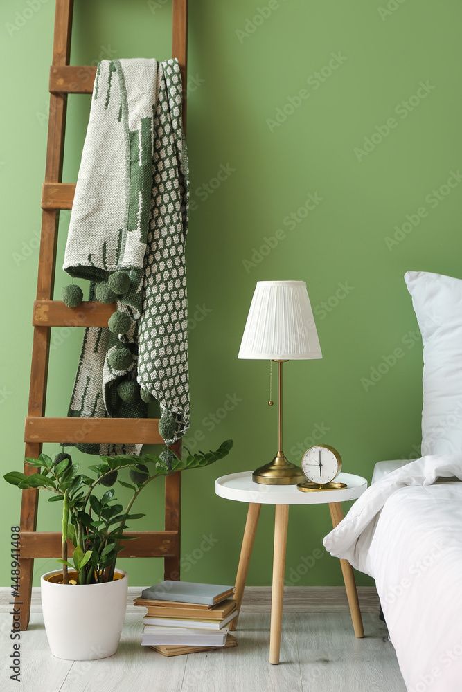 Interior of stylish bedroom with table and ladder