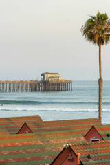 Sticker - Scenic view of a house on a wooden dock with tile roof and palm tree foreground