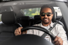Transport, Vehicle And People Concept - Happy Smiling Indian Man Or Driver In Sunglasses Driving Car
