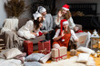 © ako-photography - group of women wearing Christmas hats make greeting video calls at Christmas time