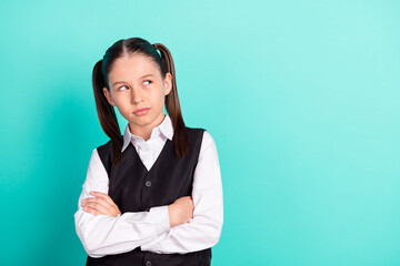 Canvas Print - Photo portrait little girl in uniform with crossed hands looking copyspace isolated pastel teal color background