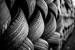 © jtrillol - Old used car tires. A pile of black tires, abstract background.