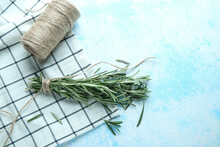 Twigs Of Fresh Rosemary On A Blue Background With Place For Text