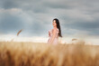 © Ann Stryzhekin - A girl in a dress with long hair in a wheat field in the evening dramatic light.