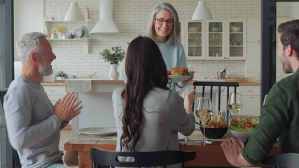 Wall Mural - Happy multi-generation family smiling while having dinner together