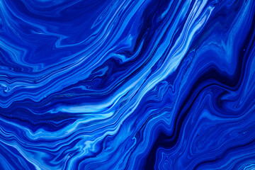 Wall Mural - Fluid art texture. Abstract backdrop with mixing paint effect. Liquid acrylic picture that flows and splashes. Classic blue color of the year 2020. Blue, white and indigo overflowing colors.