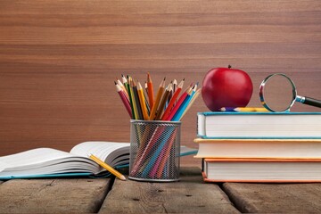 Wall Mural - Stack of vintage books and colored pencils on the desk