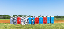 Row of colorful mobility lavatory and washbasin, hygiene facility for people at outdoor event. Public temporary restroom at a park, attendees using amenity during festival, convenience and sanitation