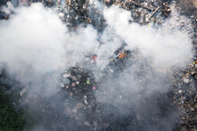 Garbage And Fire Burn In Landfill. Also Call Trash, Waste, Rubbish. Destruction With Combustion, Heat, Flame. Occurs Smoke, Toxic Cause Of Air Pollution, Environmental Damage And Global Warming.