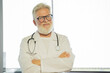 © de Art - a smiling, gray-haired old doctor