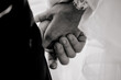 © Fraupoc - The bride and groom hold hands, close-up