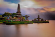 © Olga - Pura Ulun Danu Bratan temple in Bali island. Beautiful balinese temple during sunrise. Balinese landmark. Cloudy sky. Water reflection. Slow shutter speed. Bratan lake, Bali