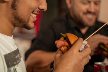 two men father and son share a delicious burger