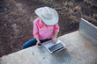 © Austockphoto - Female farmer using telecommunications device