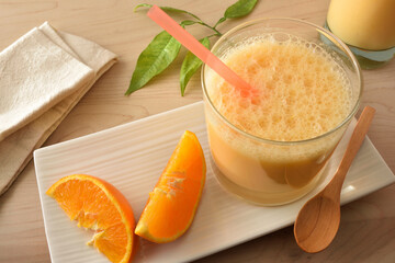 Wall Mural - Natural orange beverage with milk and fruit on table detail