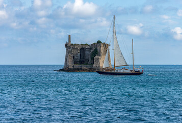 Wall Mural - The Ancient Scola Tower (Torre Scola) or of Saint John Baptist, XVII century, and a sailing boat in the Gulf of La Spezia near Porto Venere or Portovenere. La Spezia, Liguria, Italy, Europe.