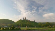 Stunning View Of Corfe Castle Bathed In Early Morning Light.