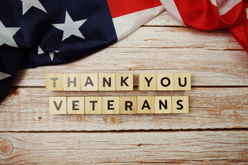 Wall Mural - Thank You Veterans alphabet letter on wooden background