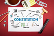 Constitution. Tea cup and office supplies on red table