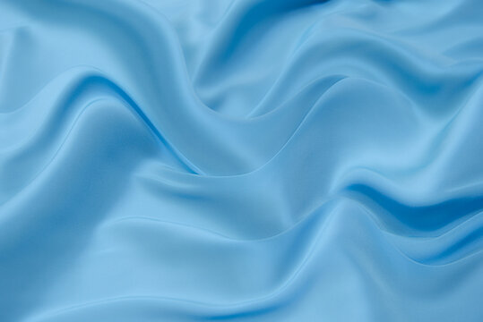 Wall Mural -  - Blue fabric texture background, wavy fabric soft blue color, luxury satin or silk cloth texture.