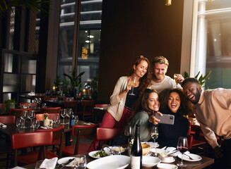 Wall Mural - Friends taking selfie on phone in restaurant