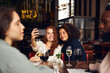 © Southworks - Friends taking selfie in wine bar