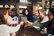 © Southworks - Friends toasting with wine in bar