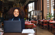 © Southworks - Portrait of cheerful restaurant owner with laptop