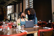 © Southworks - Restaurant owners working with laptop