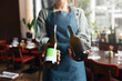 © Southworks - Waitress holding wine bottles