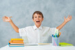 © shangarey - Back to school. Happy smiling student draws at the Desk. A schoolboy solves his homework. A boy from elementary school