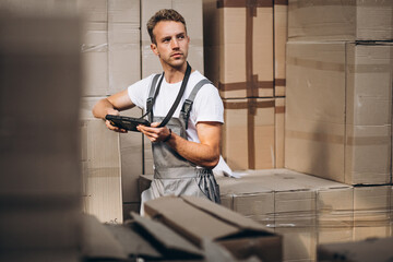 Young man working at a warehouse with boxes