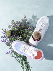 Canvas Print - White sneakers with sequins and purple flowers on turquoise background