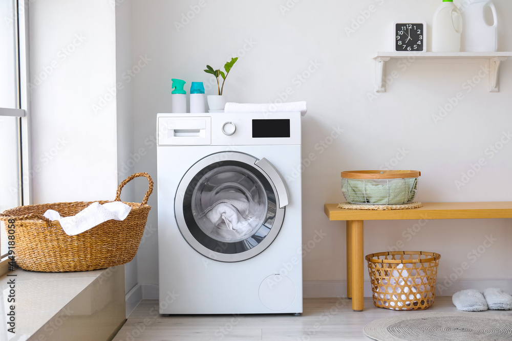 Interior of bathroom with modern washing machine