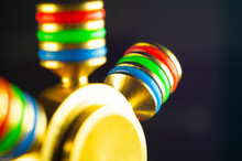 Closeup Shot Of Details On A Gold And Rainbow Fidget Spinner
