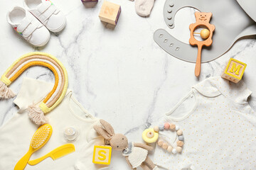 Wall Mural - Frame made of baby clothes, shoes, toys and accessories on light background