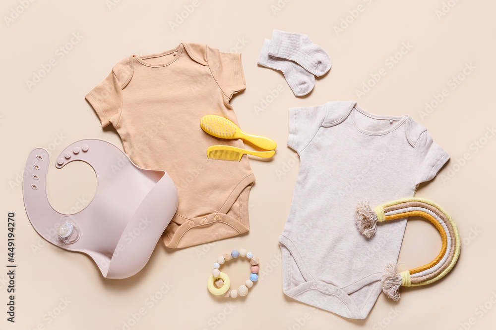Baby clothes, toys and accessories on color background