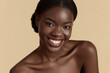 © puhhha - Portrait close up of beautiful african girl. Smiling young woman looking at camera. Concept of skincare. Isolated on beige background. Studio shoot