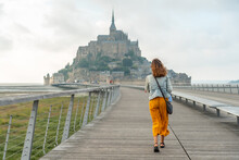 A Young Tourist Visiting The Famous Mont Saint-Michel In The Manche Department, Normandy Region, France