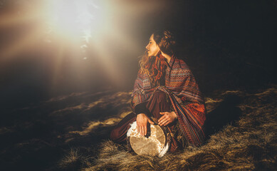 Poster - beautiful shamanic girl playing on drum in the nature.