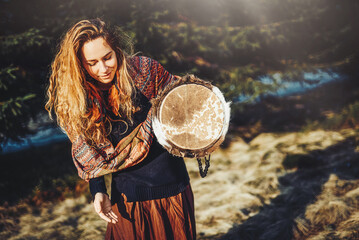 Fototapete - beautiful shamanic girl playing on drum in the nature.