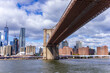 A picture of Brooklyn Bridge in New York City, USA. In the picture one can see the East River, and Manhattan skyline