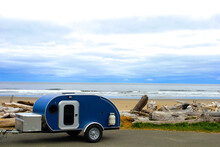 Blue Teardrop Camping Trailer At The Beach