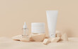 © yayha - 3d rendering of skin care beauty cosmetic product on beige background. White tube cream face, serum bottle.