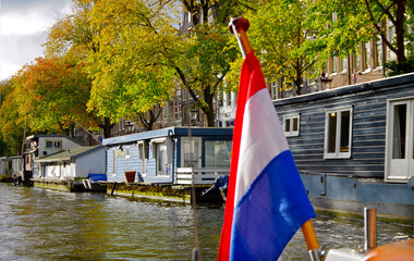 Amsterdam Netherlands dancing houses over river Amstel landmark besides Grachten canals with city skyline old town historic architecture Delft style