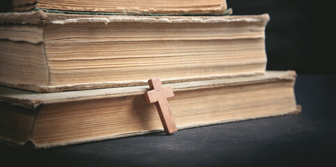Wall Mural - Christian cross and Bible on the black background.